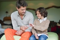 Man playing cards with his son — Stock Photo