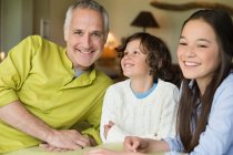 Portrait of a man with his children smiling — Stock Photo