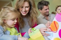 Happy family with shopping bags at home — Stock Photo