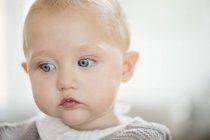 Close-up of thoughtful baby girl looking away — Stock Photo