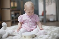 Cute baby girl playing with toys at home — Stock Photo