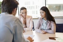 Business executive discussing with clients in office — Stock Photo