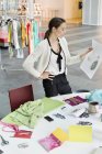 Concentrated female fashion designer working in office — Stock Photo
