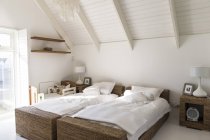 Interior of modern light bedroom with two single beds — Stock Photo