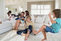 Family using electronics gadget — Stock Photo