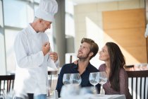 Koch spricht mit Paar im Restaurant — Stockfoto