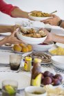 Friends having lunch at dining table, selective focus — Stock Photo