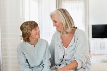 Woman and her grandson smiling at each other — Stock Photo
