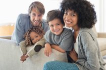 Portrait of a couple smiling with their children — Stock Photo