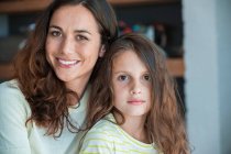 Portrait of a woman smiling with her daughter — Stock Photo