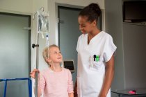 Жіноча медсестра, яка допомагає пацієнтці в лікарні — стокове фото