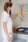 Female nurse arranging schedule in hospital — Stock Photo
