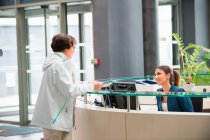 Woman discussing at reception desk — Stock Photo