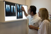 Doctors examining X-ray report in hospital — Stock Photo