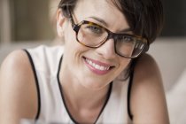 Portrait of smiling woman in eyeglasses looking at camera — Stock Photo