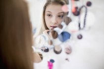 Gros plan de l'adolescente appliquant rouge à lèvres devant le miroir — Photo de stock