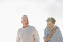 Close-up of laughing senior couple walking together outdoors — Stock Photo