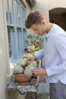 Focused man potting plants outdoors — Stock Photo