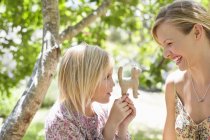 Little girl and mother looking at toy outdoors — Stock Photo