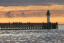 France, North Coast. Calais. The pier over sea water surface at sunset — Stock Photo