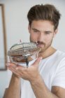 Young man holding model boat, selective focus — Stock Photo