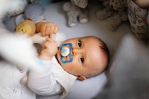 8 months baby boy in his bed — Stock Photo