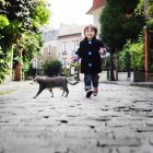 Little boy running in a cobbled narrow street — Stock Photo