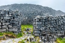 Europe, Republic of Ireland, County Galway, Aran Islands, Inishmore Island, cliffs dug by the sea near the Dun Aengus prehistorical Ringfort site (1100 BC - 800 AC) (National Monument) — Stock Photo