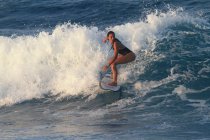 Beautiful surfer in ocean — Stock Photo