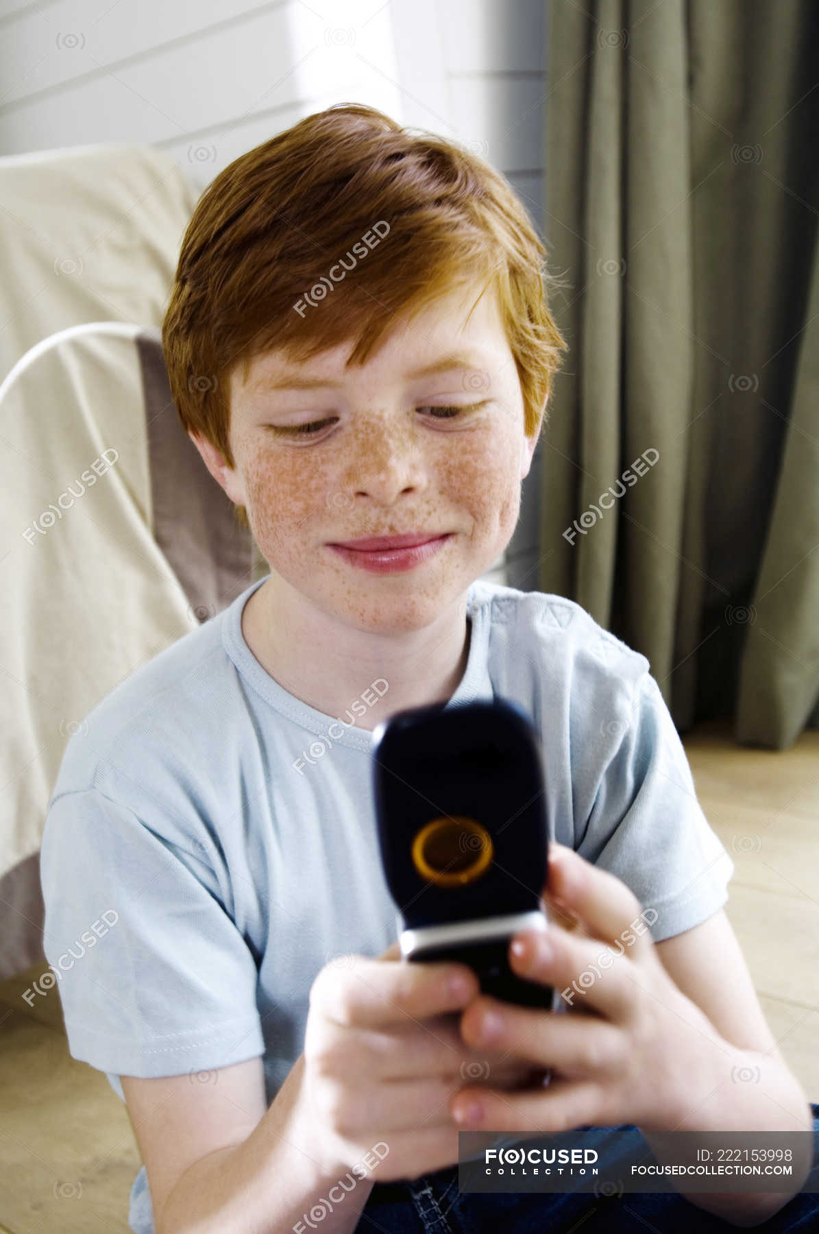 Little Redheaded Boy With Freckles Using Mobile Phone Domestic