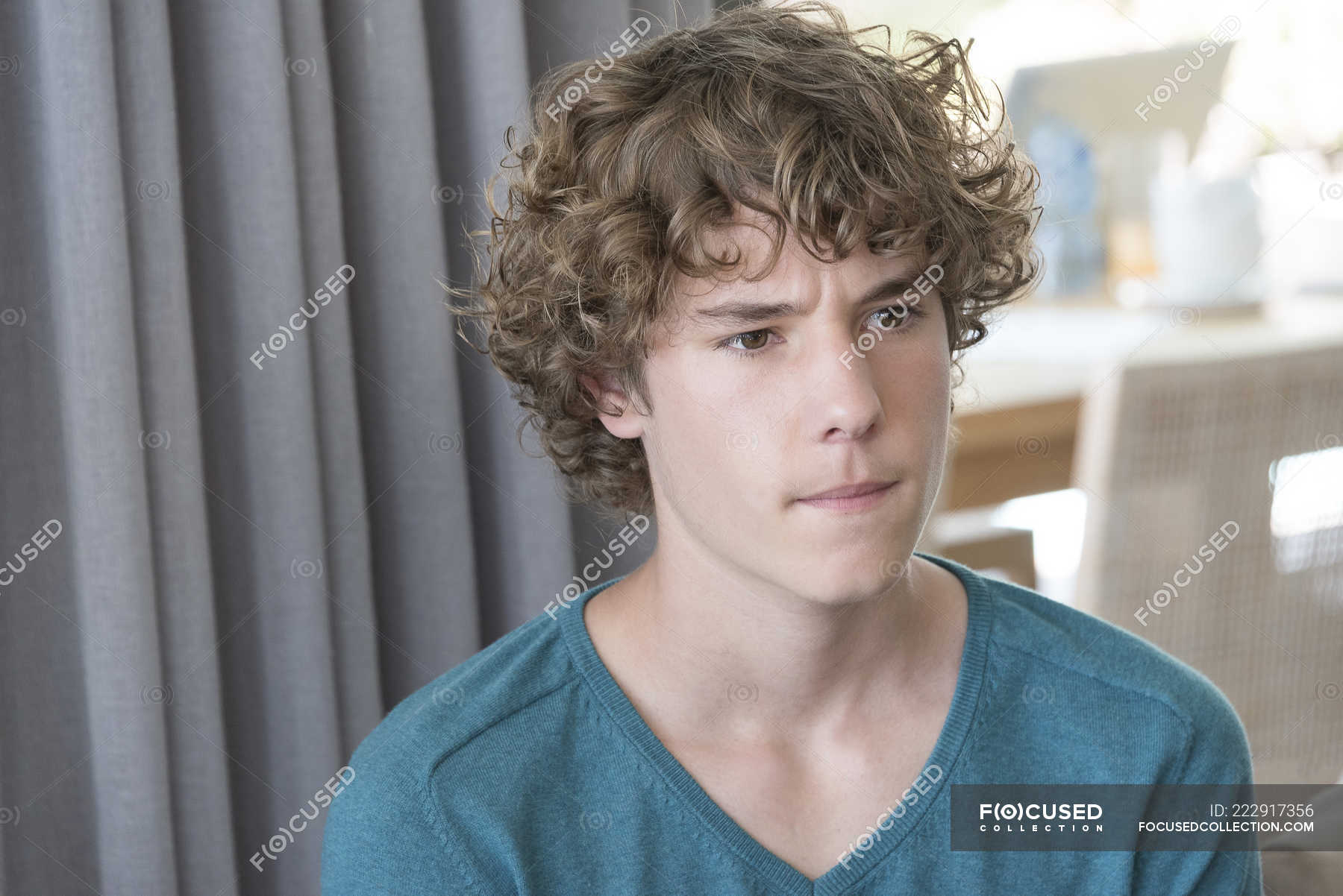 Close-up of teenage boy with curly hair thinking — room, Anxiety - Stock  Photo | #222917356
