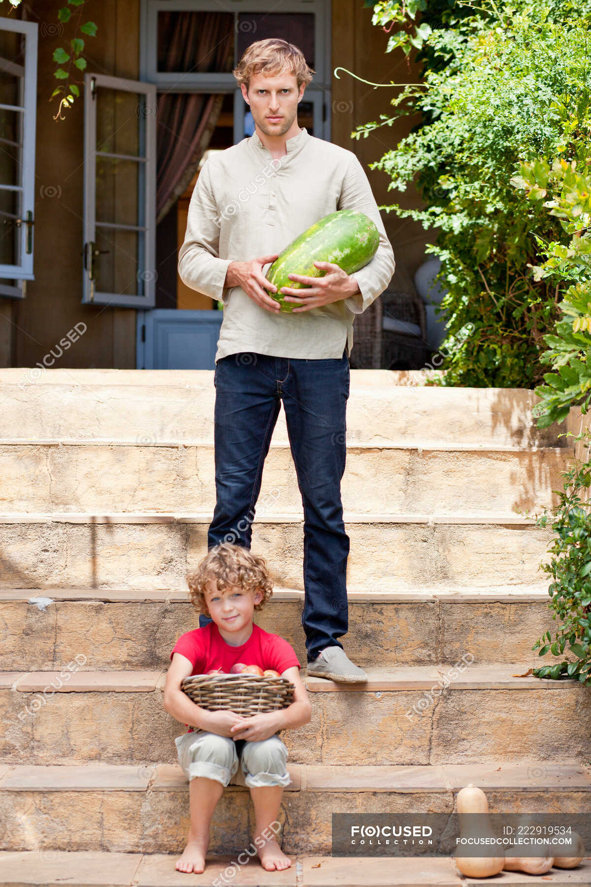 Father and son carrying fruits — rare vegetable, parents - Stock Photo