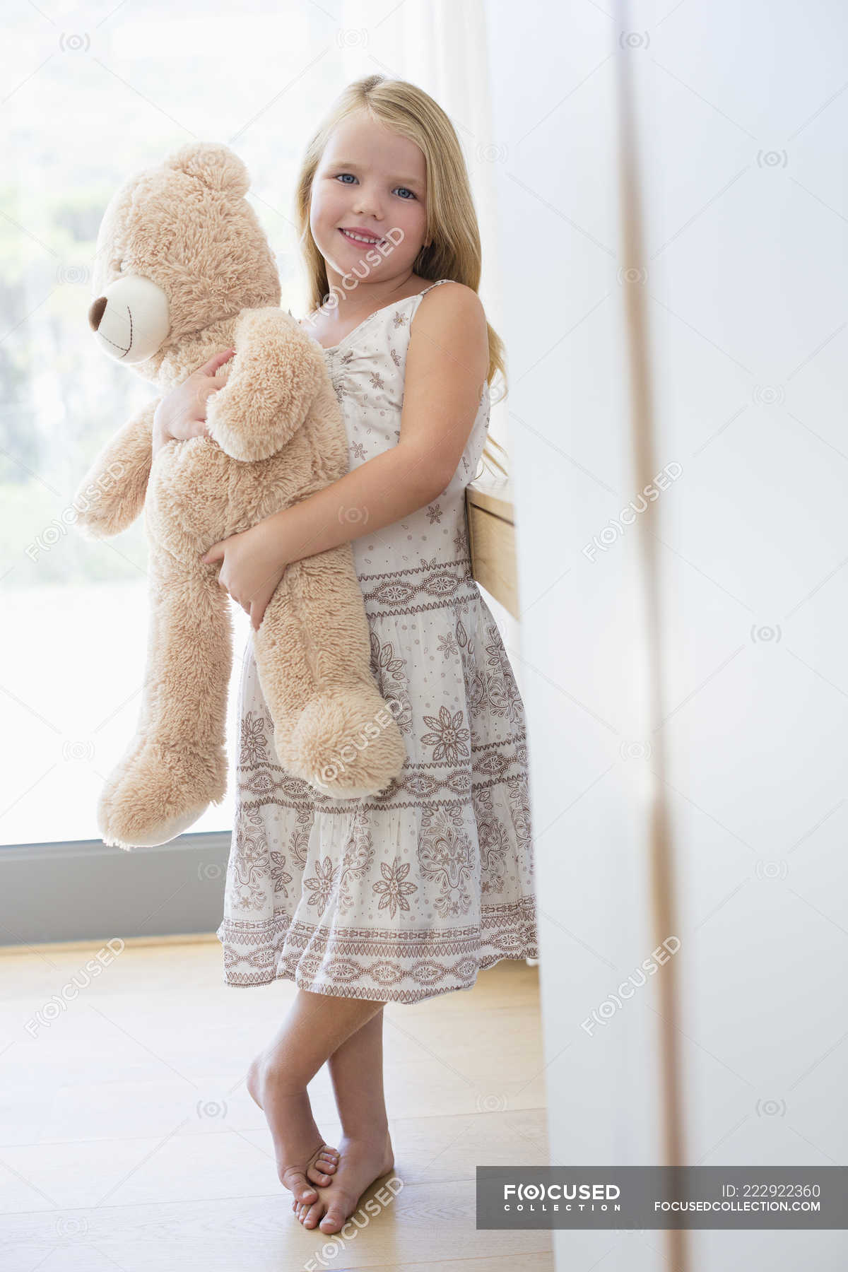 girl holding teddy