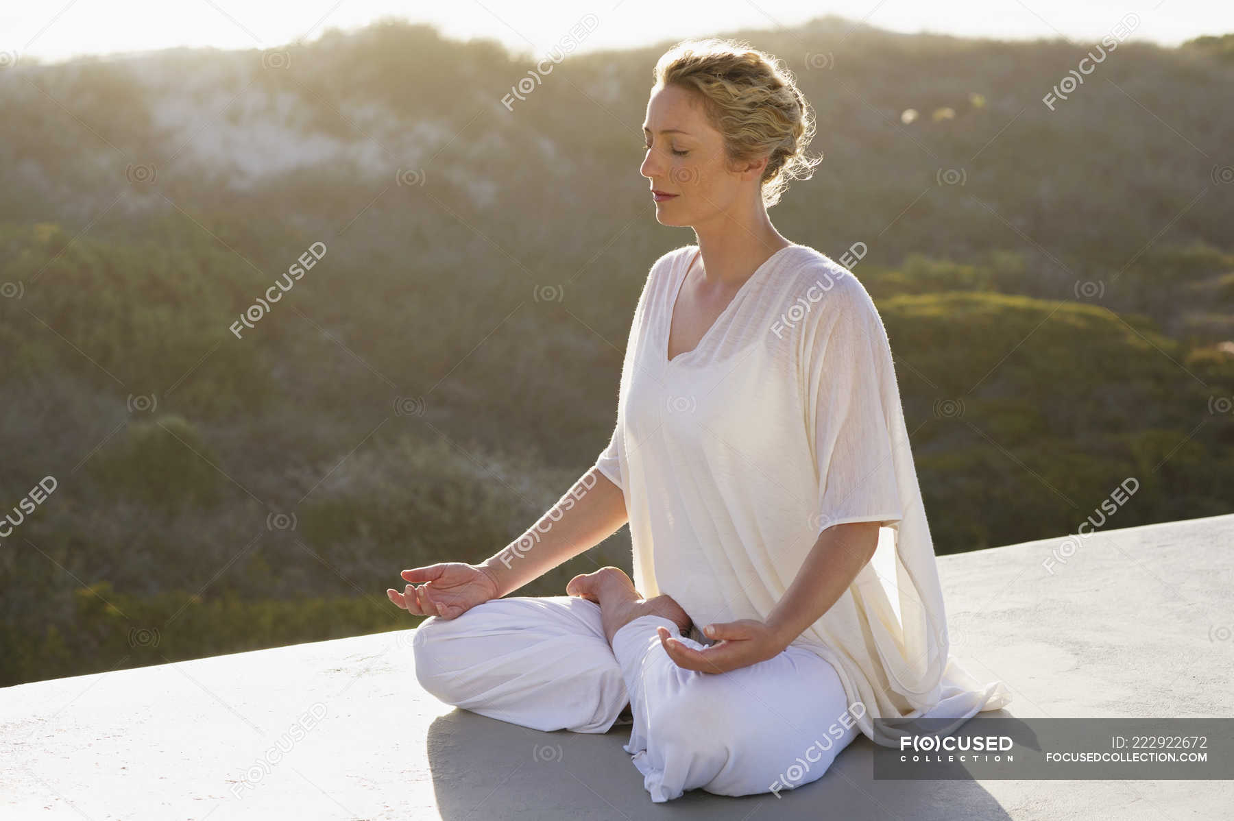 Relaxed woman in white outfit meditating in nature — caucasian ethnicity,  shadow - Stock Photo | #222922672