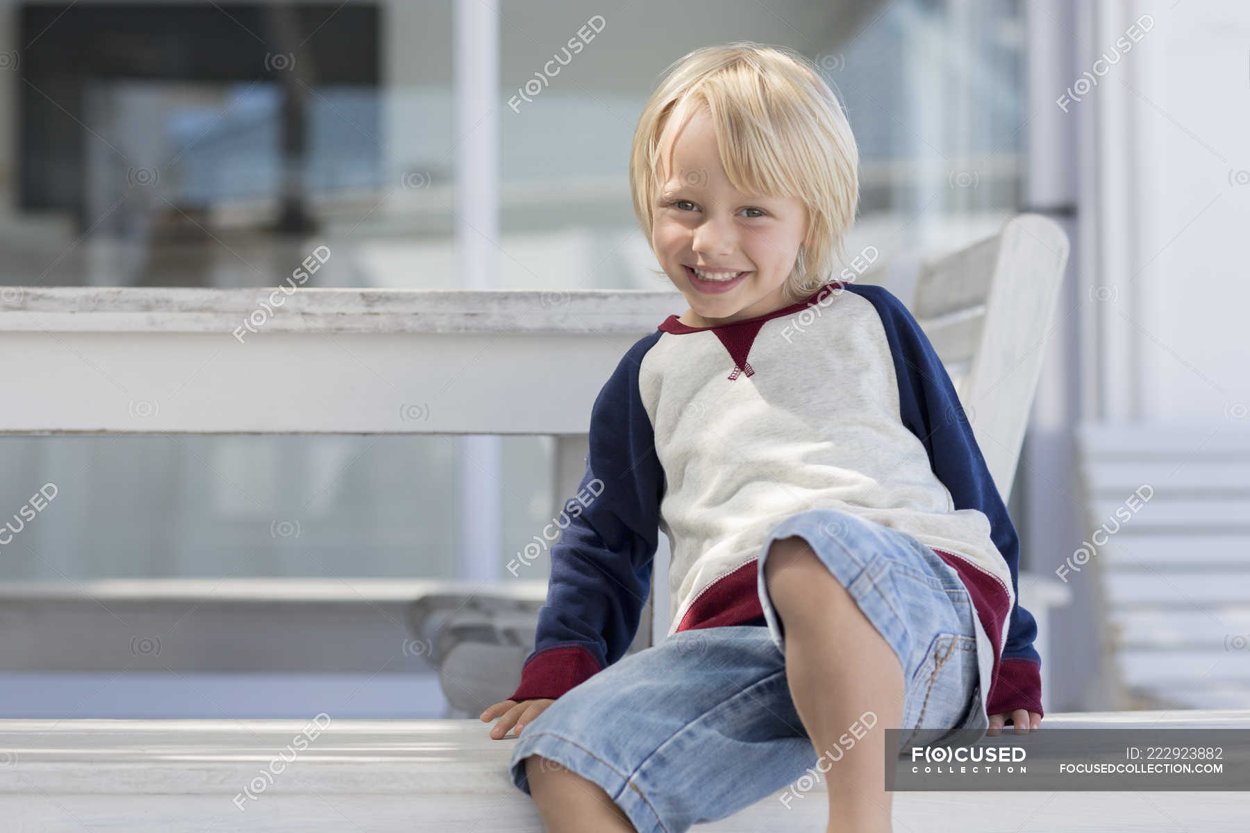 Portrait Of Happy Little Boy With Blonde Hair Smiling Outdoors