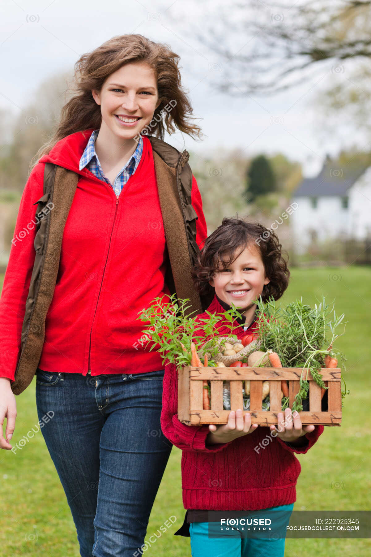 mother-and-son-with-a-crate-of-homegrown-vegetables-single-parent