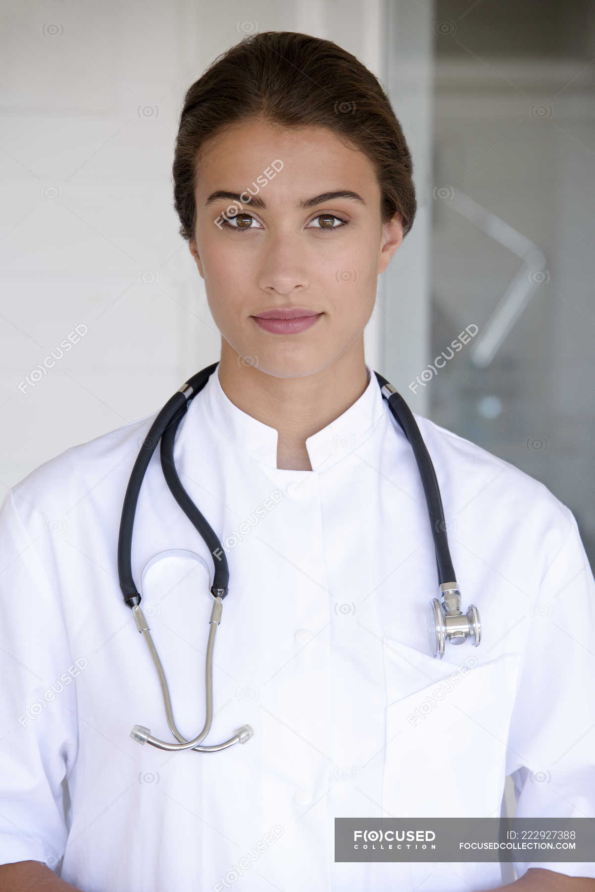 Portrait Of Confident Female Doctor Standing And Looking At Camera — Focus On Foreground 7563