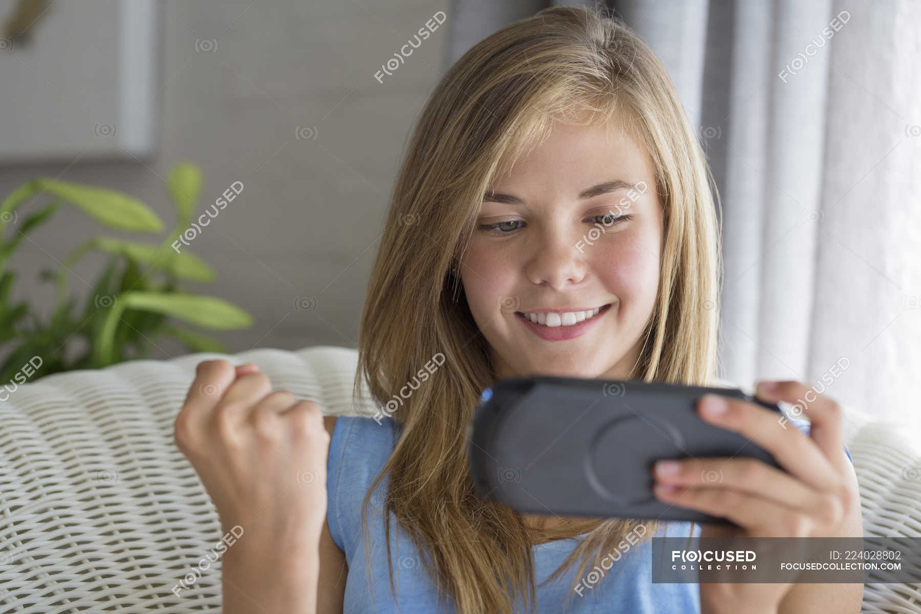 Close-up of smiling teenage girl using mobile phone — pleasure ...