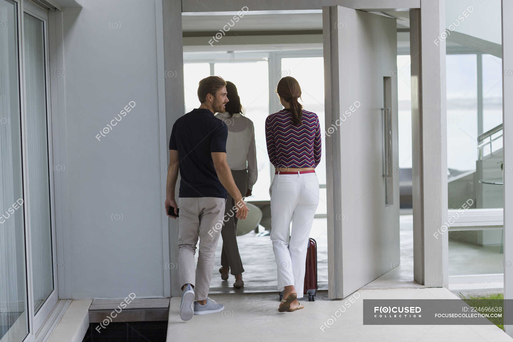 Couple With Suitcase Entering To Friend House Arrival Friendship Stock Photo 224696638