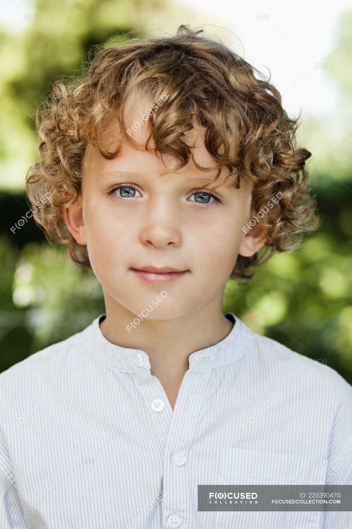 Close-up of smiling boy with curly hair in white shirt — happiness, little  boy - Stock Photo | #225390470