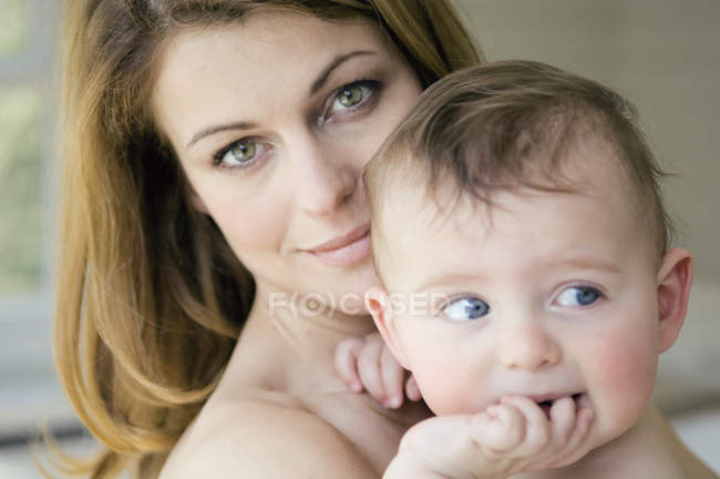 Portrait of mother holding baby boy — Stock Photo