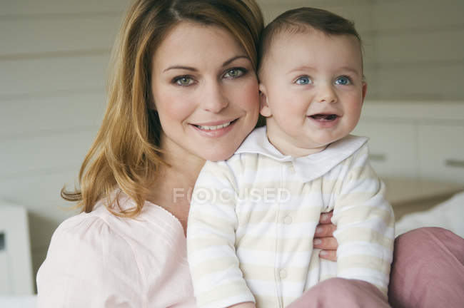 Portrait of smiling young woman and baby boy — Stock Photo