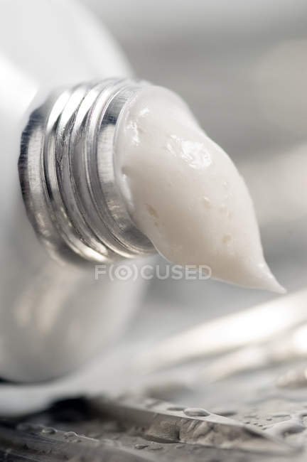 Close-up of open metal tube of moisturizer — Stock Photo