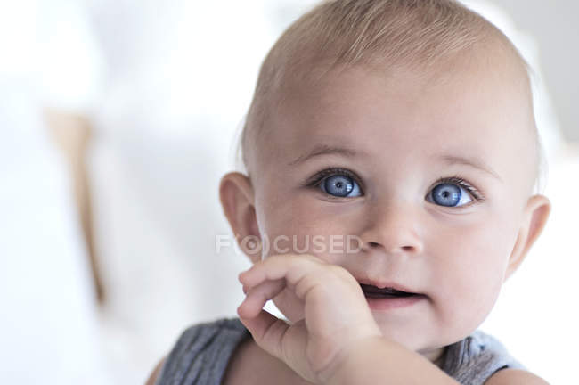 Portrait of thoughtful baby boy with blue eyes — Stock Photo