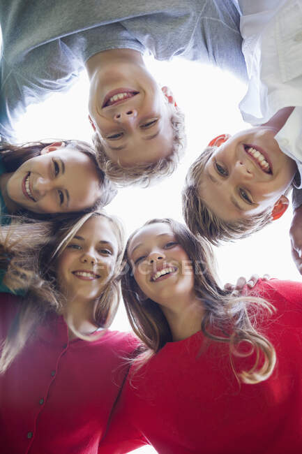 Low angle view of friends in a huddle — Stock Photo