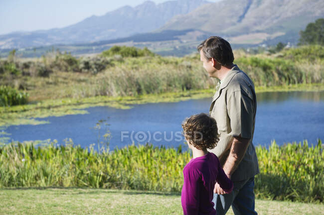 Father and son looking at the pond — Stock Photo