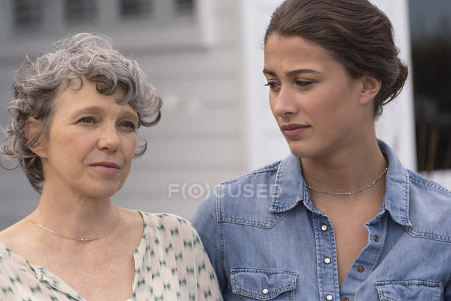 Portrait of sad mother with young daughter outdoors — Stock Photo