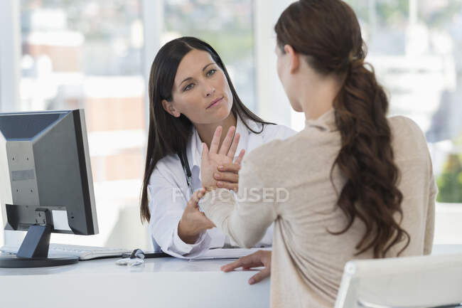 Female doctor examining a patient — Stock Photo