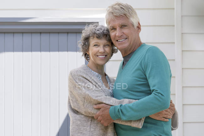 Portrait d'un couple de personnes âgées aimant embrasser à l'extérieur de la maison — Photo de stock