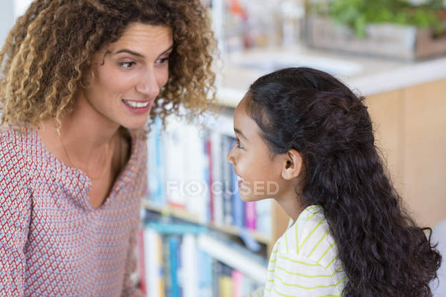 Close-up of smiling mother and daughter looking at each other — Stock Photo